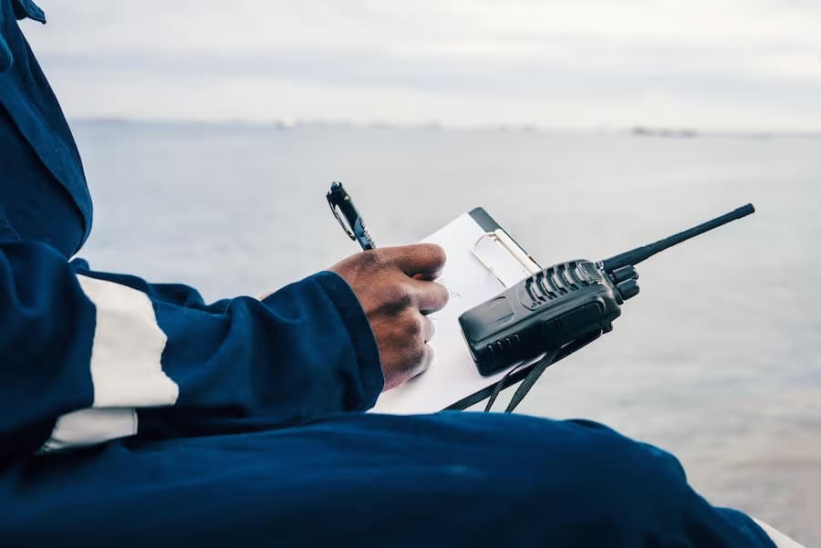 Surveyor with handheld radio completing a checklist